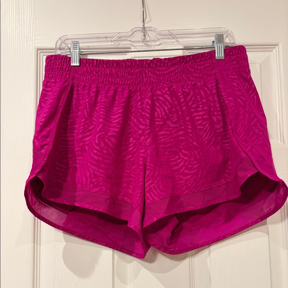 Pink Athleta running shorts.